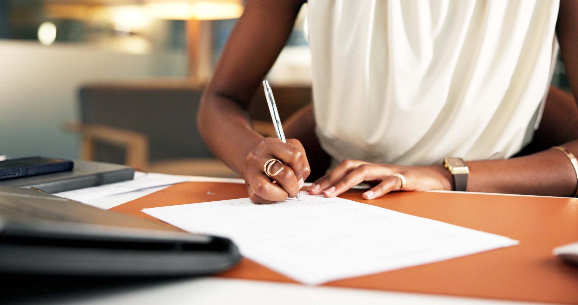 Woman of color signing legal documents